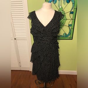 Overlapping layers of subtle ruffles and fully lined polyester crepe